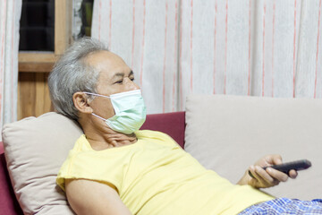 Senior grey-haired man  are at home wearing masks. Caution to prevent coronavirus by wearing a protective mask.