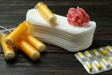 Concept of menstruation on wooden background, close up