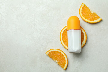Blank orange deodorant on white textured background