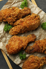 Concept of tasty eating with fried chicken on dark wooden background