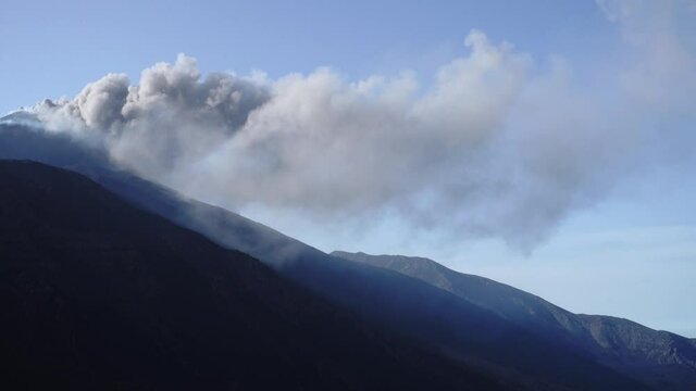 panorama from plume ash eruption of South-East crater of Etna Volcano in Sicily to "Bove" valley and oriental coast and sea (panning - 28 may 2021)