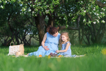 nature scene with family outdoor lifestyle. Mother and little daughter playing together in a park. Happy family concept. Happiness and harmony in family life.