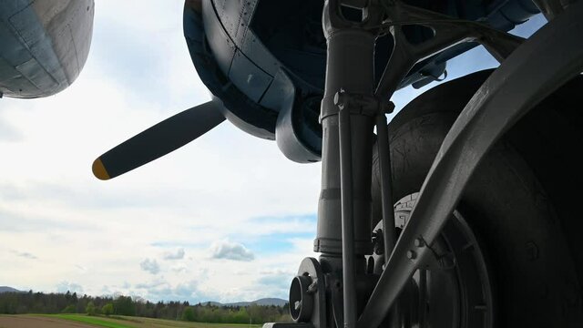Close up view of decommissioned aero plane, a memorial to partisans and their help to Allied air forces during WWII. Aircraft exhibit in Slovenia. View under the airplane. Tilt down