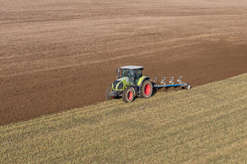 aerial view of the tractor on harvest field