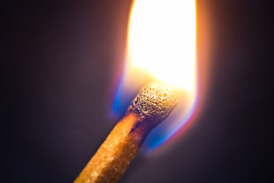 burning match on a black background