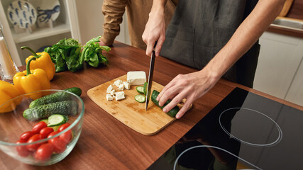Same-sex male couple preparing salat together