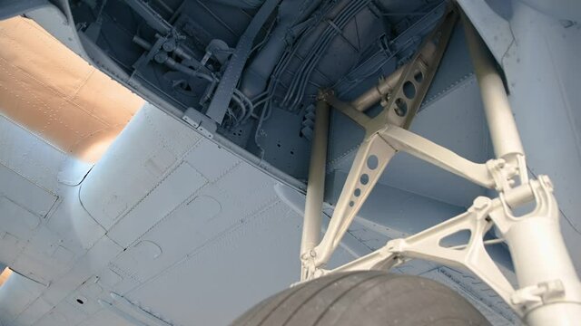 Decommissioned aero plane, a memorial to partisans and their help to Allied air forces during WWII. Aircraft exhibit in Slovenia. View under the airplane. Tilt down