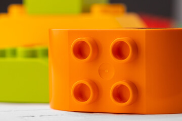 Toy building kit details on wooden background