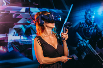 Virtual reality. A woman plays games in a virtual reality helmet.