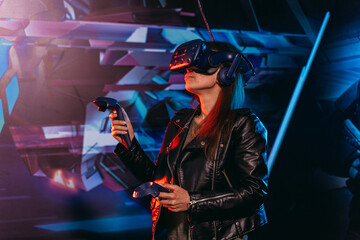 Virtual reality. A woman plays games in a virtual reality helmet.