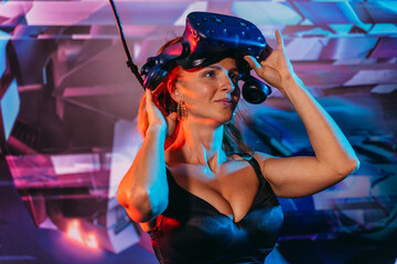 Virtual reality. Woman puts on a virtual reality helmet.