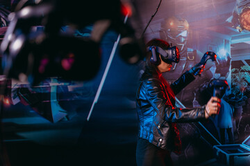 Virtual reality. A woman plays games in a virtual reality helmet.