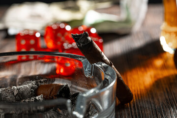 Close up of cigar and red dice cubes, gambling concept