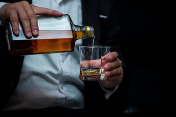 Closeup businessmen holding a glass of whiskey