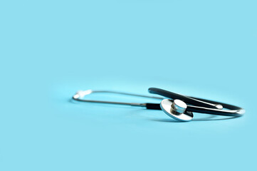 Black Stethoscope isolated on blue background in the nursing room at Thailand. Concept Medical & Health Care. Selective Focus.