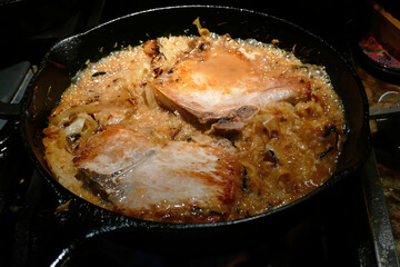 Shot of a preparation process of the wine-braised pork chops in a pan.
