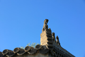 Fototapeta na wymiar Ancient brick carving works in the background of blue sky, North China