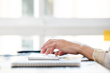 Woman hands typing on computer keyboard on the table