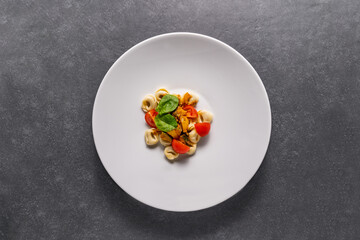 plate with tagliatelle mushrooms and tomatoes 