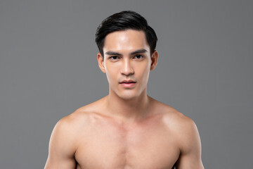 Young shirtless handsome Southeast Asian man with healthy glowing clear face skin for men beauty...