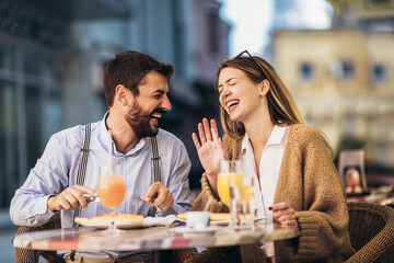 Smiling Couple On Date Enjoying Pizza In Restaurant Together