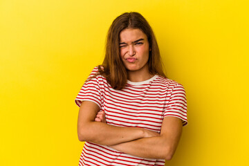 Obraz premium Young caucasian woman isolated on yellow background unhappy looking in camera with sarcastic expression.