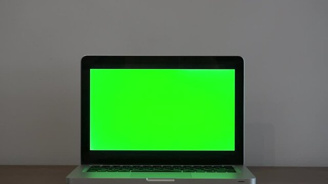 Laptop mockup screen background. Empty computer screen on desktop in home office against white wall background