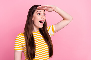 Fototapeta premium Profile photo of joyful young millennial lady look empty space wear orange t-shirt isolated on pastel pink color background