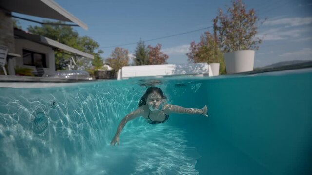girl swimming in a pool in summer