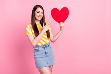Fototapeta na wymiar Photo of flirty millennial lady point heart wear orange t-shirt skirt isolated on pastel pink color background