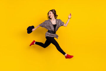 Fototapeta na wymiar Full body profile side photo of happy nice young woman look empty space run jump sale isolated on yellow color background