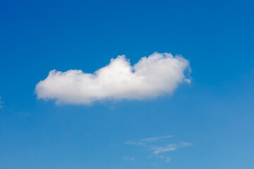 Naklejka na ściany i meble Blue clean summer sky with one white cloud. Copyspace