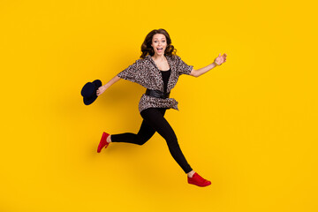 Fototapeta na wymiar Full body profile side photo of amazed happy young woman jump run empty space isolated on yellow color background