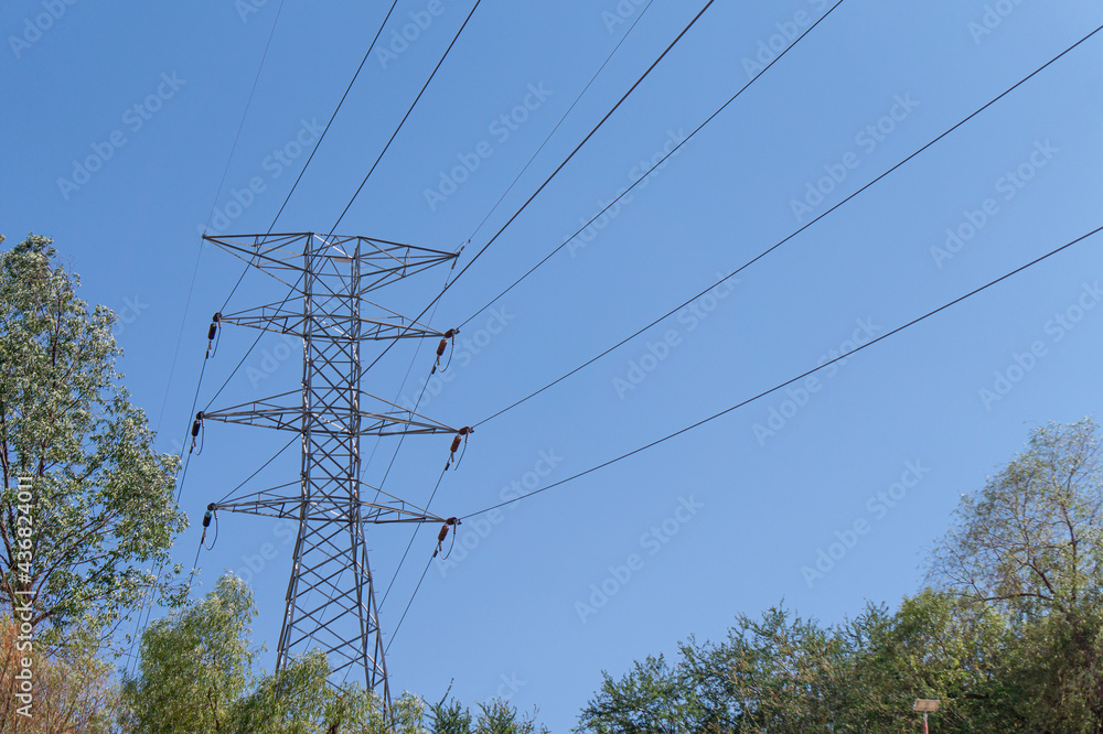 Wall mural Scenic view of high-voltage powerlines under a clear blue sky