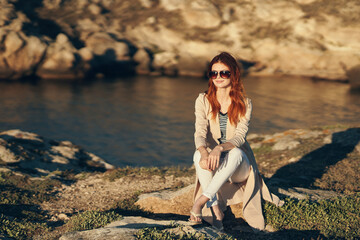 traveler in nature in the mountains in glasses and in a sweater landscape