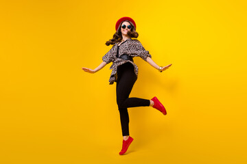 Fototapeta na wymiar Full length body size view of attractive cheerful fashionable girl jumping having fun good mood isolated over bright yellow color background
