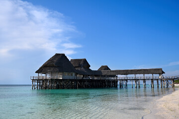 Tropical beach with the concept of summer holidays and travel. The tropical beach is an amazing beauty. A sandy beach, on the shore of which there are hotels. Great view of the ocean from the hotel.