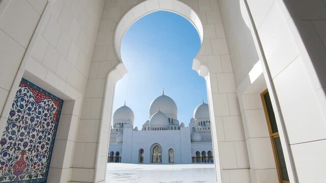 Sheikh Zayed Grand Mosque in Abu Dhabi, United Arab Emirates. Dolly in with sunbeam