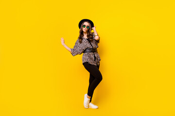 Fototapeta na wymiar Full body photo of glamour attractive nice young woman wear luxury outfit look empty space isolated on yellow color background