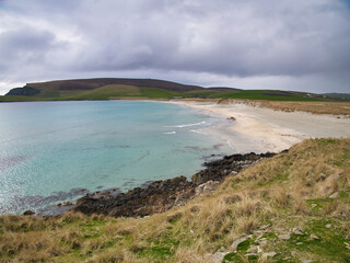 With Fitful Head in the background, the pristine, clear water of Quendale Beach in the south of...