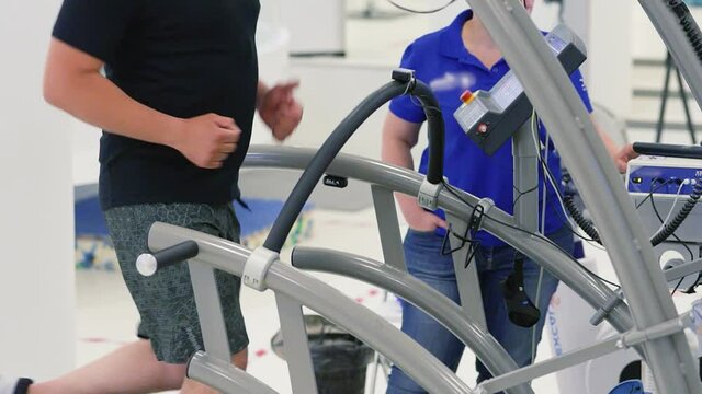 Man athlete going trough the Vo2 Max testing on treadmill in modern sport science lab. triathlete workout testing endurance preparing to the race. Professional sport analyzing