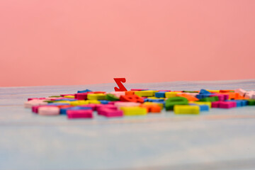 Lots of multicolored letters on the table and the letter z stands out.
