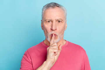 Portrait of attractive mysterious grey-haired man showing shh sign keep silence isolated over...