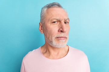 Portrait of attractive suspicious strict grey-haired man looking at you isolated over bright blue color background