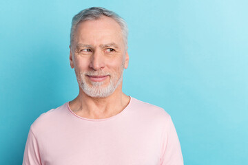 Portrait of attractive minded grey-haired man looking aside thinking copy space isolated over bright blue color background