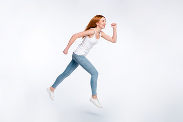 Full size photo of funky orange hairdo lady go wear white top jeans isolated on bright color background