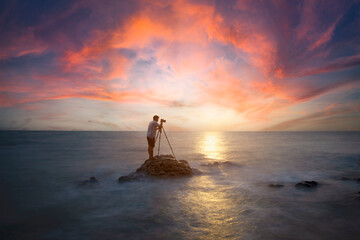 Nature photographer,Beautiful stone background on the beach at sunset .
