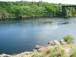 Panorama from a sunny glade on a variety of green colors shaded by clouds on the opposite bank of the Dnieper.