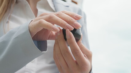 Young business woman enjoying favorite music from playlist on smartphone via modern headphones with good sound and stereo enjoying walking on street. Young girl pulls headphones out of the box