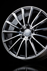 sport alloy wheel, vertical photo on a black background. slim sports spoke rim, light weight car...